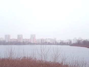 Buildings in city against sky during winter