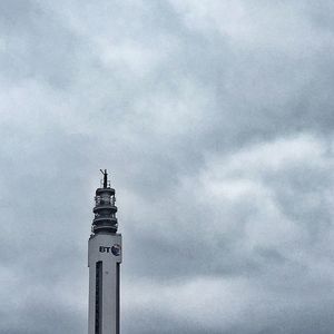 Low angle view of building against cloudy sky