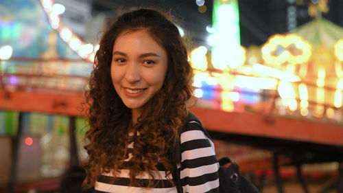 Portrait of smiling woman at night