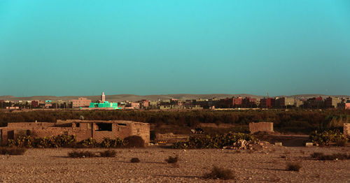 Built structures on field against clear sky