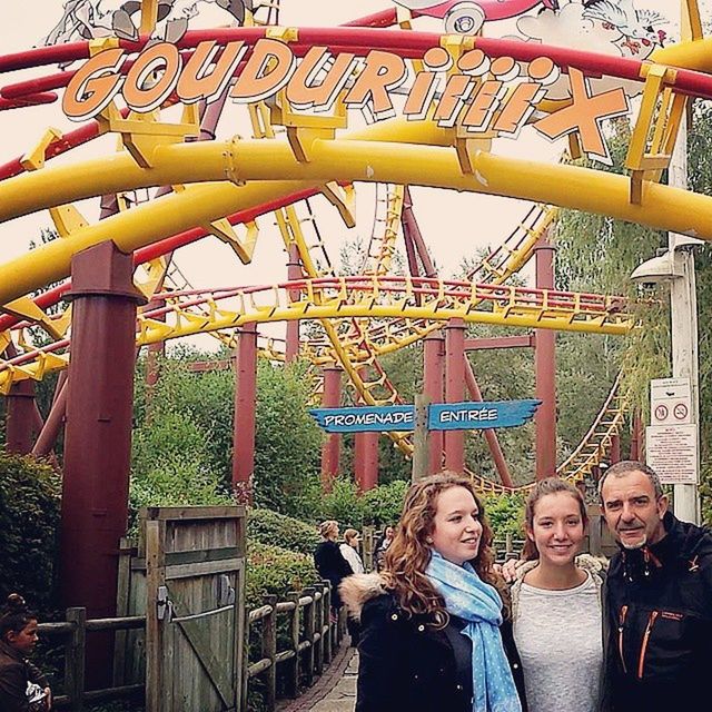 lifestyles, leisure activity, casual clothing, standing, person, childhood, built structure, amusement park, architecture, young adult, fun, tree, men, boys, full length, railing