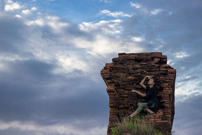 Low angle view of statue against cloudy sky