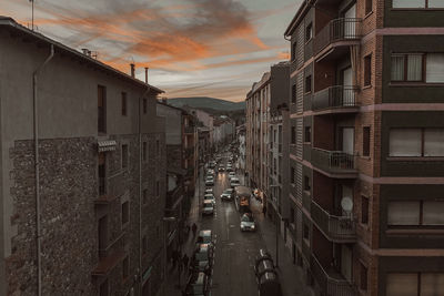 Panoramic view of street amidst buildings against sky during sunset