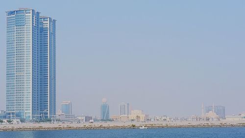 Modern buildings in city against clear sky