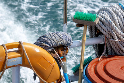 Close-up of rope tied on bollard against sea