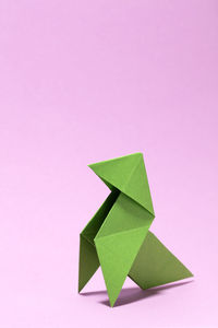 High angle view of green paper against colored background