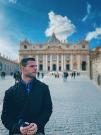 Man standing in front of historical building