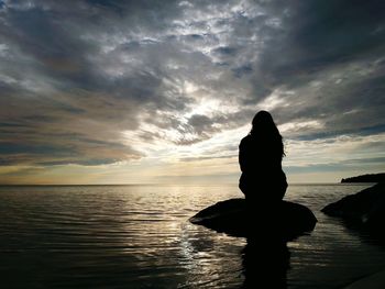 Scenic view of sea against cloudy sky