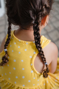 Little girl with braids in yellow dress