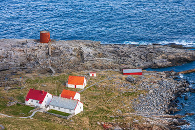 Old lighthouse and houses on the coast of norway