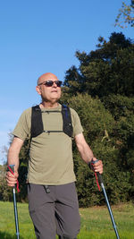 Portrait of young man standing against clear sky