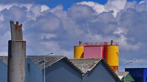 Low angle view of industrial building against sky