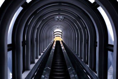 Low angle view of covered escalator in building