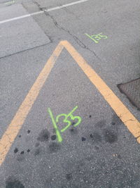 High angle view of arrow sign on road