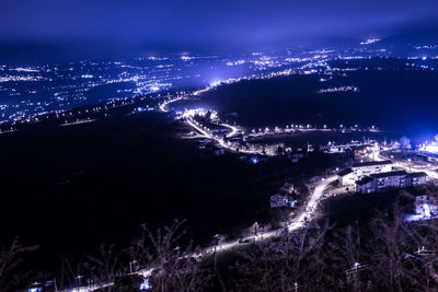 High angle view of illuminated buildings in city at night