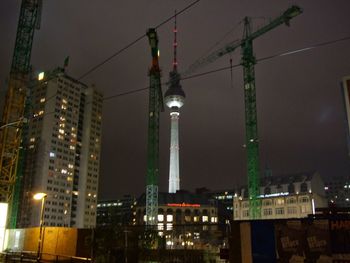 Low angle view of illuminated building against sky at night