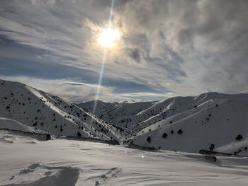 Scenic view of snowcapped mountains against sky during winter