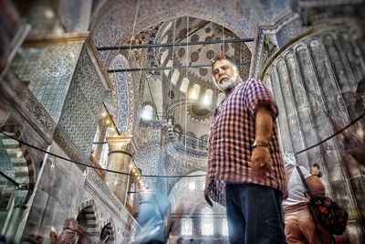 Low angle view of people standing in temple