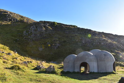 Built structure on mountain against clear blue sky