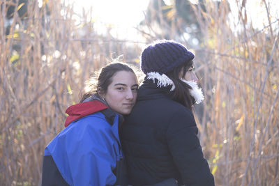 Portrait of daughter with mother on field