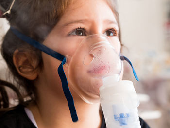 Close-up portrait of a boy drinking glass