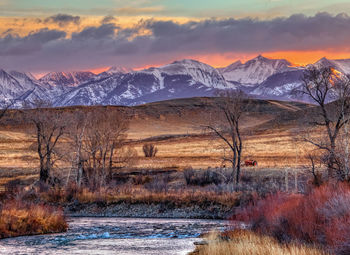 Scenic view of snowcapped mountains against sky during sunset