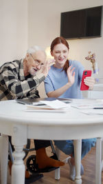 Senior man talking on video call with nurse at rehab center