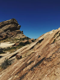 Scenic view of rocky mountains against clear blue sky