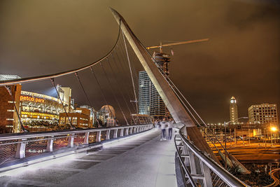 Illuminated bridge and buildings at night