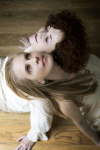 Portrait of young woman sitting on bed at home