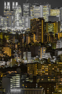 Digital composite image of illuminated buildings in city at night