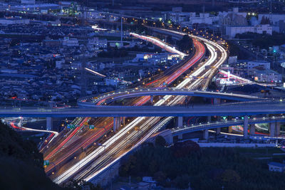 High angle view of light trails on highways at night