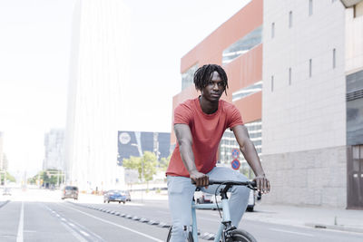 Man riding bicycle on embankment