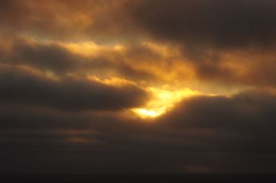 Low angle view of storm clouds in sky during sunset