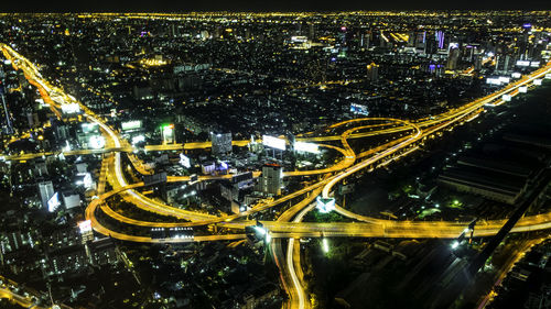 Aerial view of city lit up at night