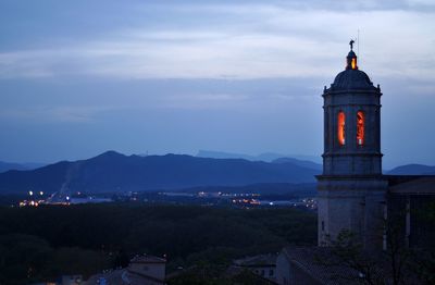 Tower amidst buildings in city against sky