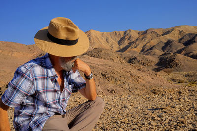 Rear view of man standing at desert