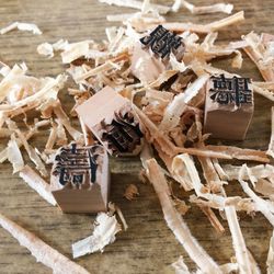 High angle view of text on blocks with shavings on wooden table at workshop