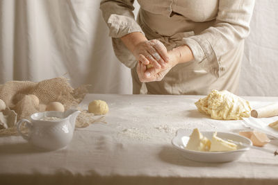 Midsection of woman preparing food on table