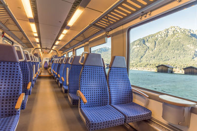 Interior of empty train against river