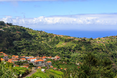 Scenic view of sea and buildings against sky