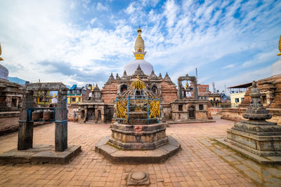 Statue of temple against buildings