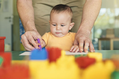 Midsection of man playing with toys