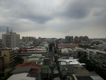 Cityscape against cloudy sky