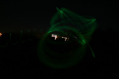 Close-up of illuminated lights over black background