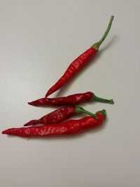 Close-up of red chili peppers on table