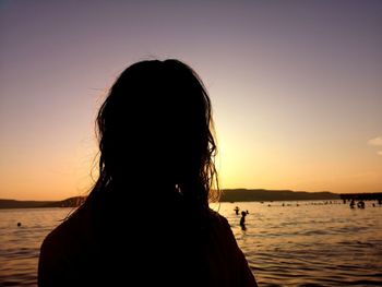 Portrait of silhouette woman against sea during sunset
