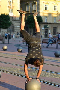 Man balancing on sphere at tramway