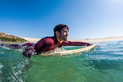 Portrait of young woman swimming in sea