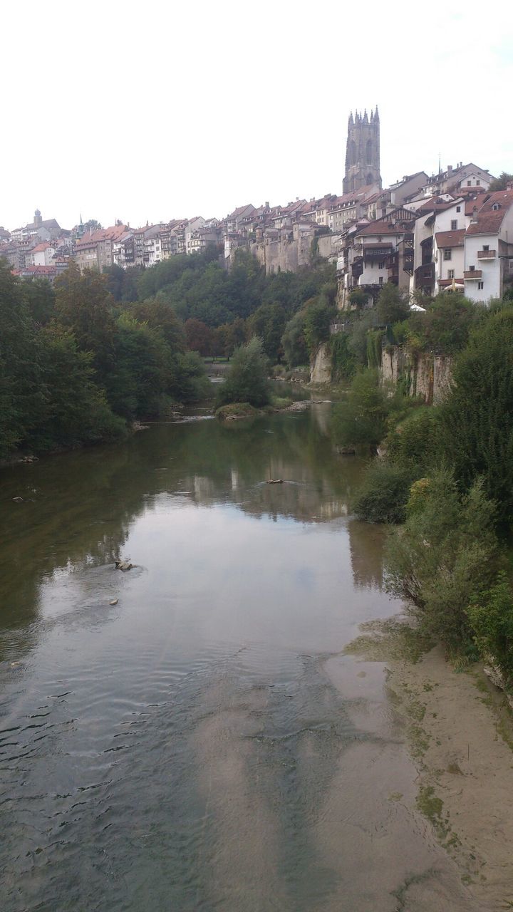 architecture, built structure, building exterior, water, reflection, tree, clear sky, river, waterfront, growth, riverbank, sky, outdoors, day, nature, town, place of worship, scenics, no people, tranquility, beauty in nature